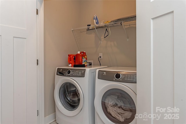 laundry area with washing machine and dryer