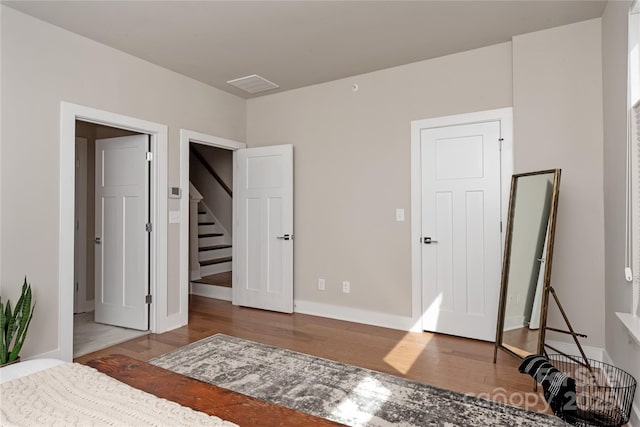 bedroom with hardwood / wood-style flooring