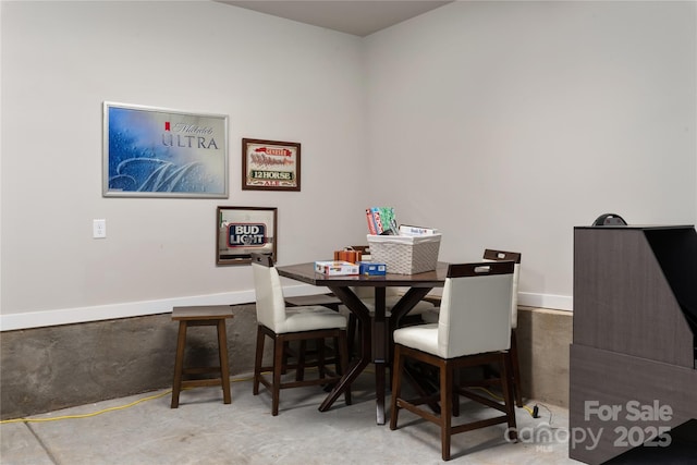 dining space featuring concrete floors