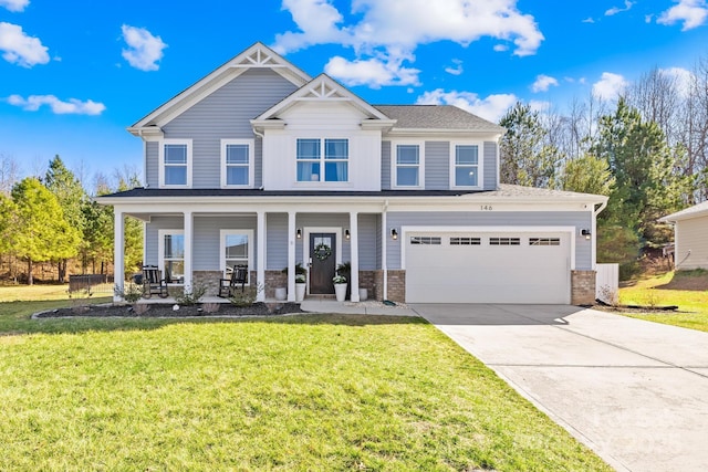 craftsman house with covered porch, concrete driveway, a front yard, and an attached garage