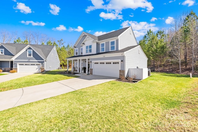 view of front of house with driveway, a garage, a front lawn, and brick siding