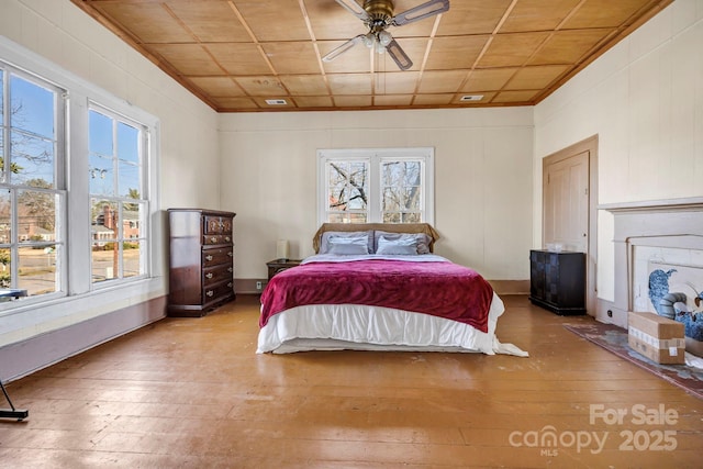 bedroom featuring multiple windows and light hardwood / wood-style floors