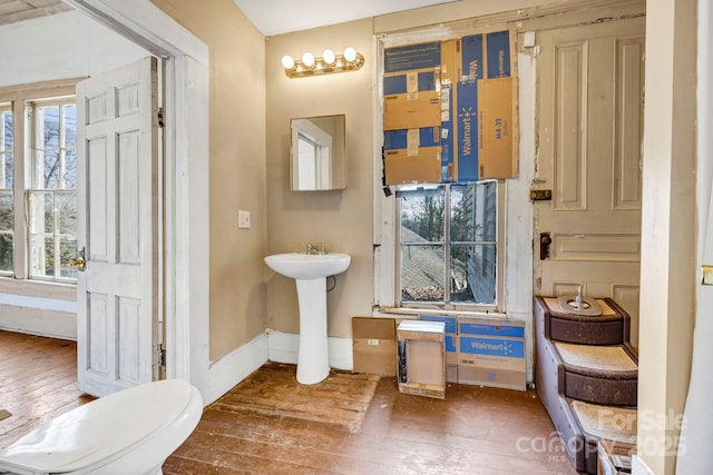 bathroom featuring hardwood / wood-style floors, plenty of natural light, sink, and toilet