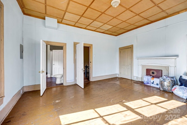 unfurnished living room with coffered ceiling, hardwood / wood-style floors, and electric panel