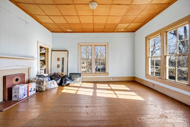 unfurnished living room featuring crown molding and hardwood / wood-style floors