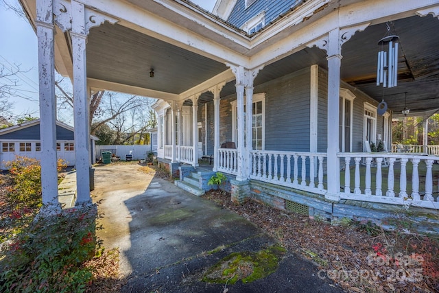 exterior space featuring a porch, a garage, and an outdoor structure