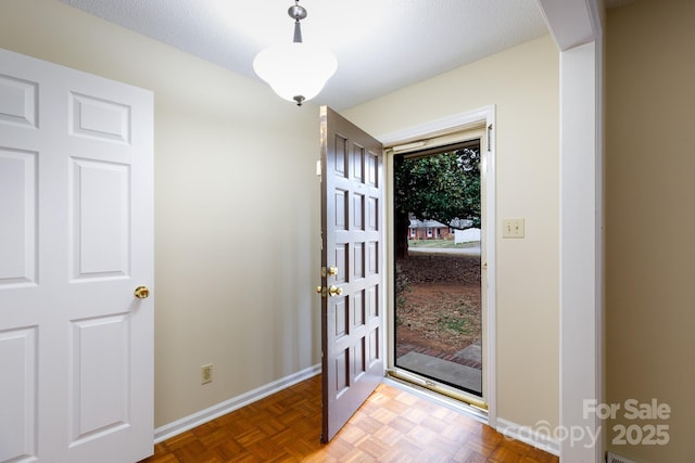 entrance foyer featuring parquet flooring