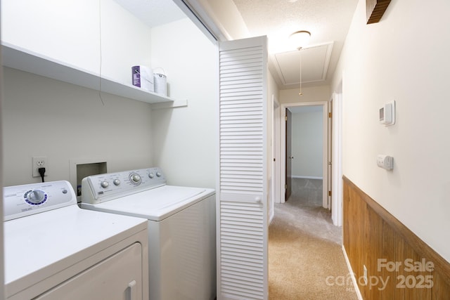 laundry room featuring separate washer and dryer and light colored carpet