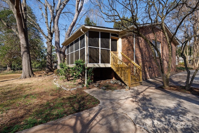 view of front of house with a sunroom