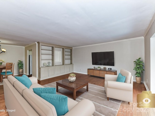 living room with crown molding, light hardwood / wood-style floors, and a chandelier