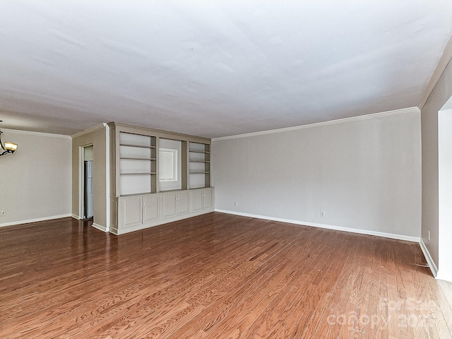 unfurnished living room with hardwood / wood-style flooring, ornamental molding, and a chandelier