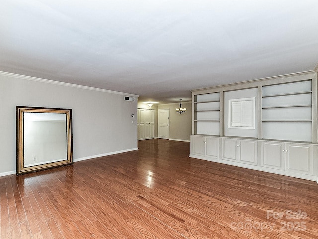 unfurnished living room with ornamental molding, wood-type flooring, and a notable chandelier