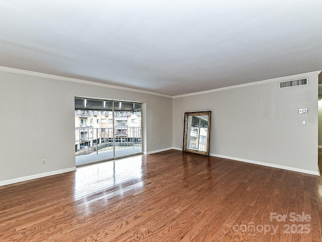 unfurnished room with wood-type flooring and ornamental molding