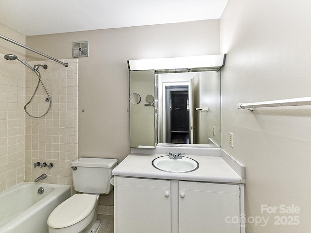 full bathroom with vanity, tiled shower / bath combo, and toilet