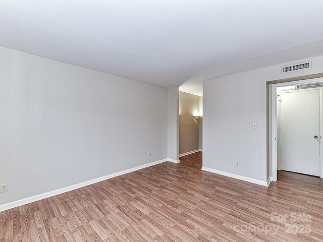 spare room with light hardwood / wood-style flooring