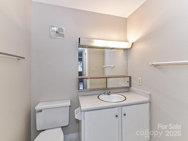 bathroom with vanity and toilet