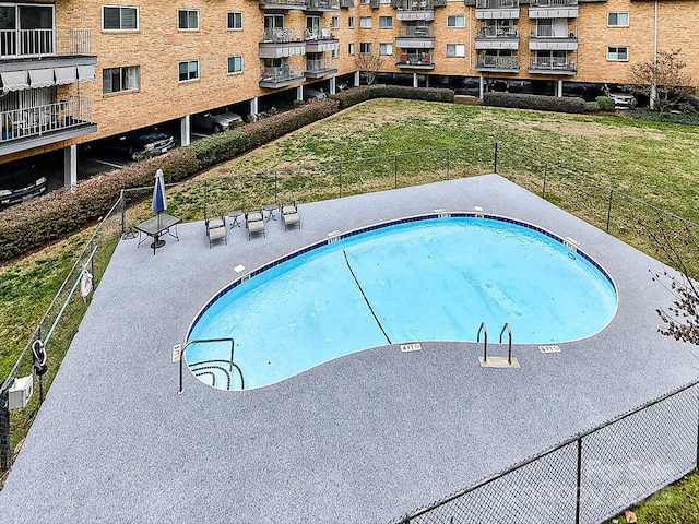 view of swimming pool featuring a lawn