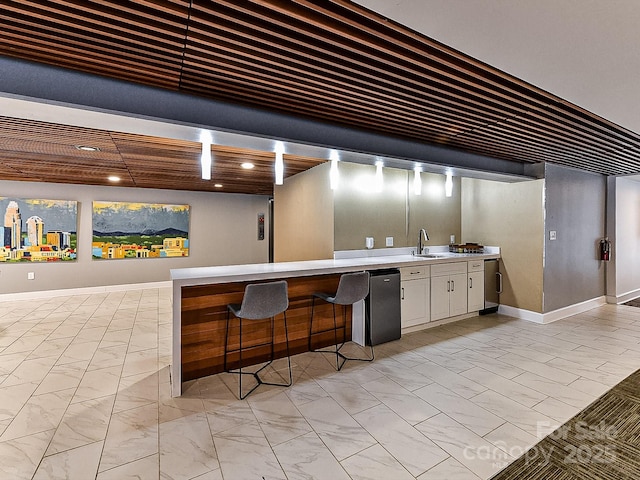 bar featuring refrigerator and sink