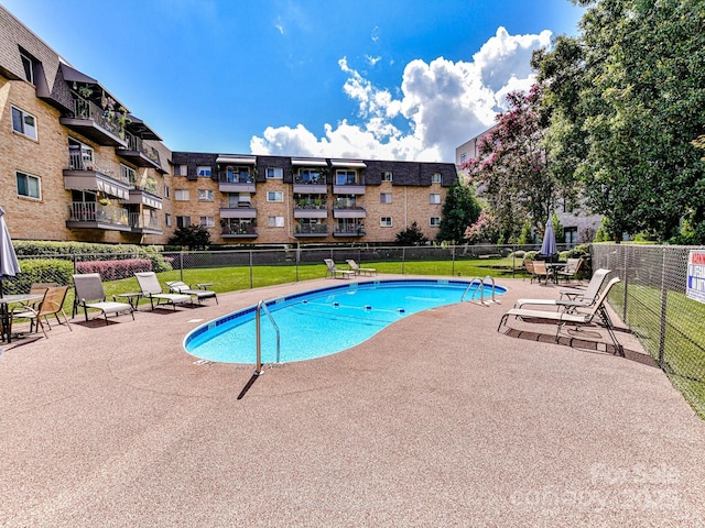 view of swimming pool with a patio