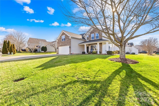 view of front of home with a front lawn, a garage, and a porch