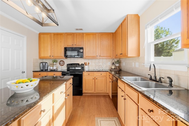 kitchen with light brown cabinetry, light wood-type flooring, black appliances, ornamental molding, and sink