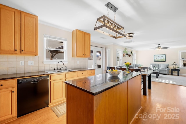 kitchen featuring light hardwood / wood-style floors, dishwasher, a kitchen island, and sink