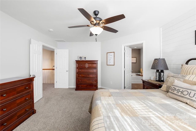 bedroom with ensuite bathroom, ceiling fan, and light colored carpet