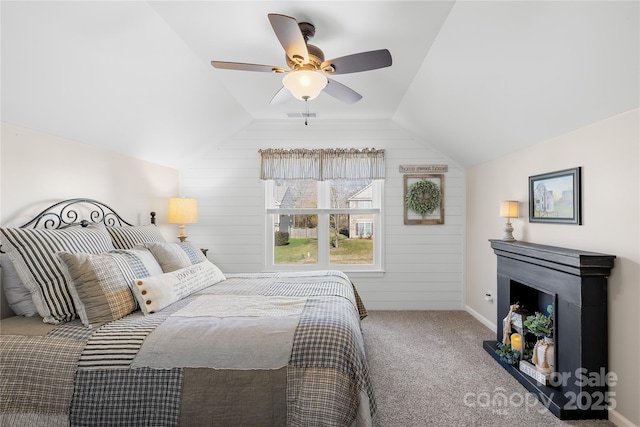 carpeted bedroom with vaulted ceiling and ceiling fan