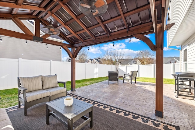 view of patio featuring outdoor lounge area, grilling area, ceiling fan, and a gazebo