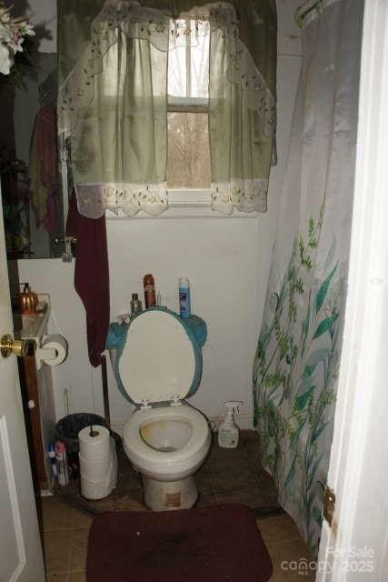 bathroom with tile patterned floors and toilet