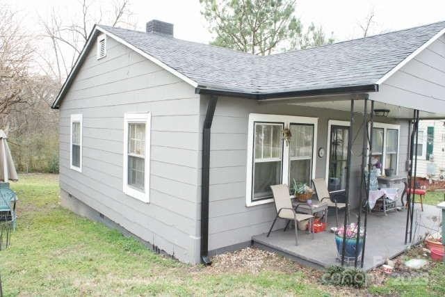 rear view of property with a lawn and a patio area