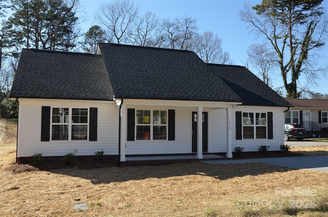 view of front of house with a porch and a front lawn