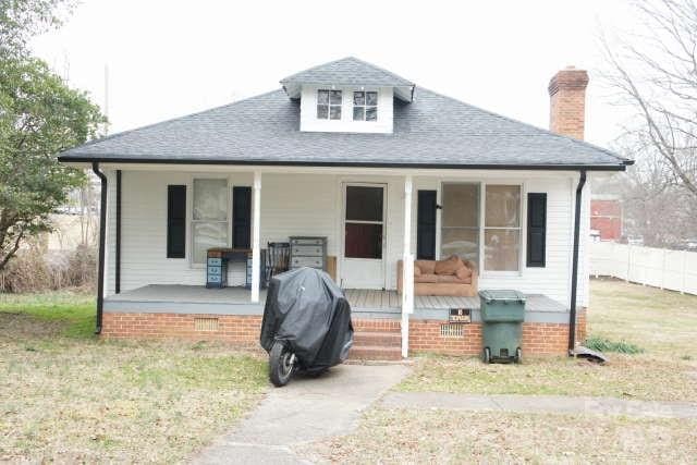 bungalow with a porch and a front yard