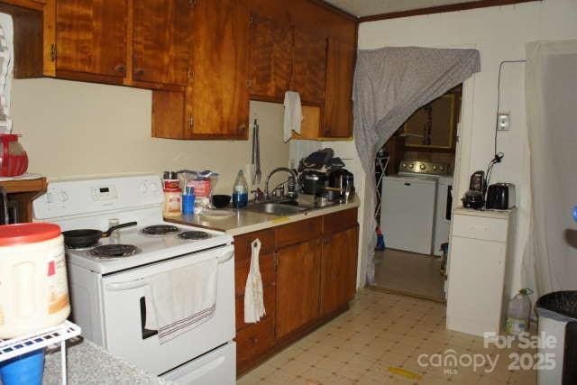 kitchen with white electric range oven and sink