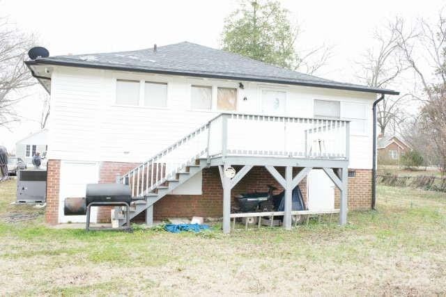 rear view of property with a yard