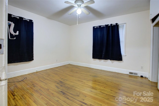 spare room with hardwood / wood-style flooring and ceiling fan