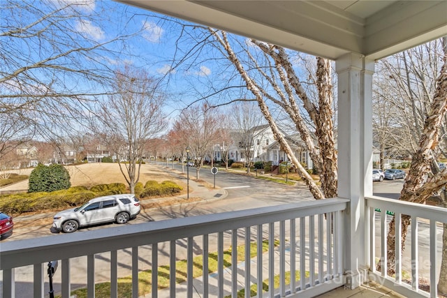 balcony featuring covered porch and a residential view