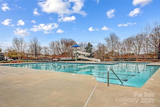 pool with fence and a water slide