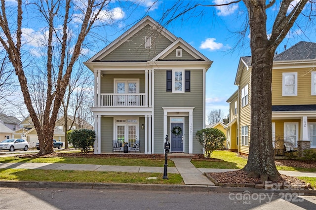 view of front of property with a balcony and french doors