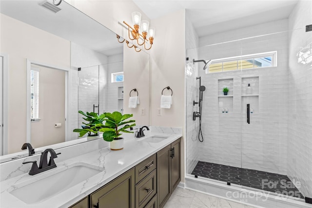 bathroom featuring double vanity, marble finish floor, visible vents, and a sink