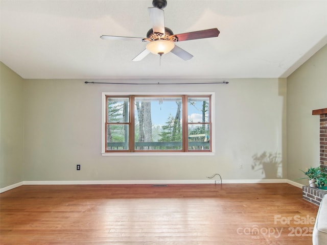 unfurnished room with ceiling fan and hardwood / wood-style floors