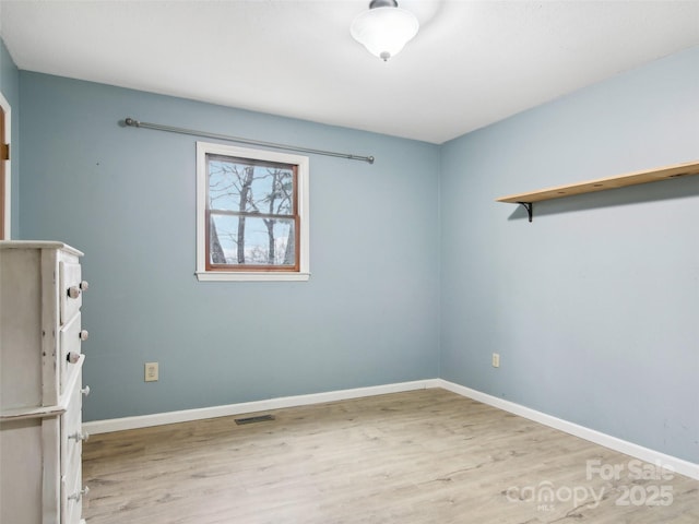 spare room featuring light hardwood / wood-style floors