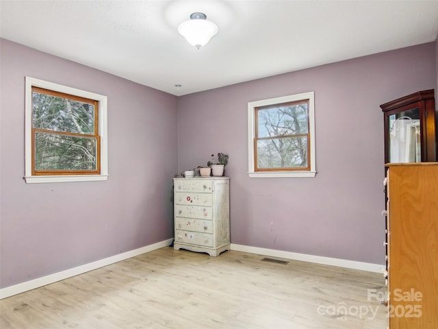 unfurnished bedroom with light wood-type flooring