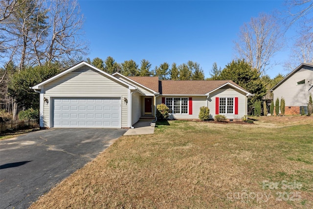 ranch-style house featuring driveway, an attached garage, and a front yard