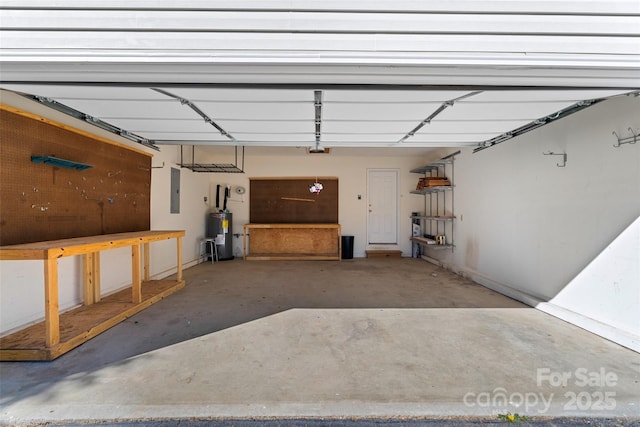 garage featuring water heater, a garage door opener, and electric panel