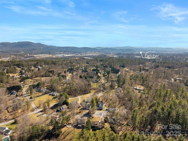 aerial view with a mountain view and a wooded view