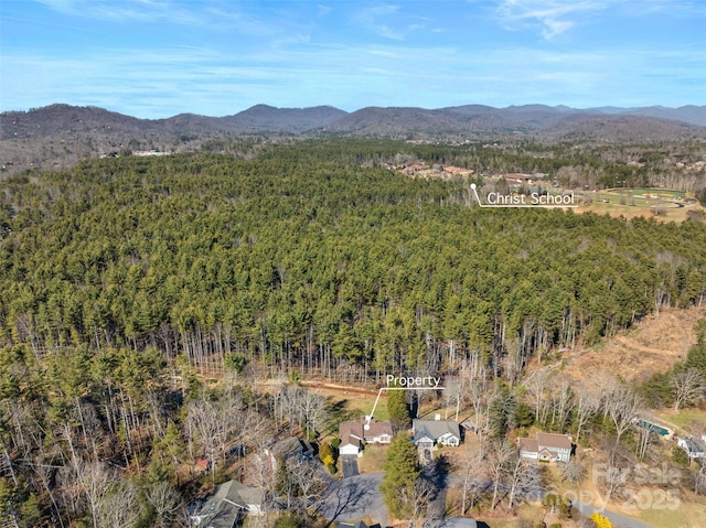 bird's eye view with a mountain view and a wooded view