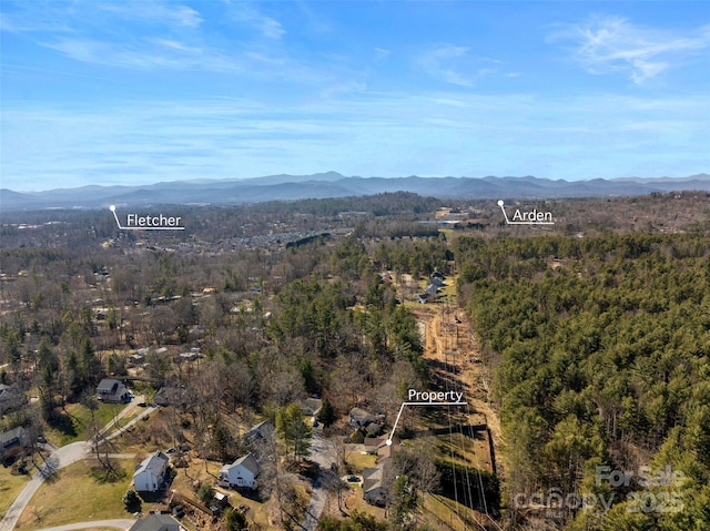 drone / aerial view featuring a view of trees and a mountain view