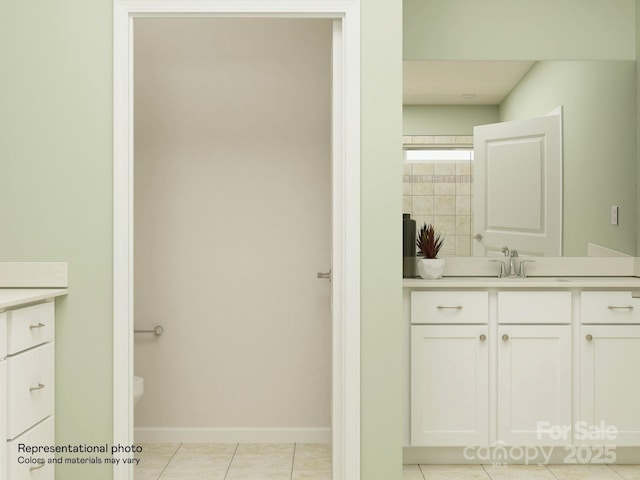 bathroom with vanity, tile patterned floors, toilet, and baseboards