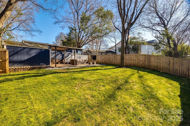 view of yard with a deck and a fenced backyard